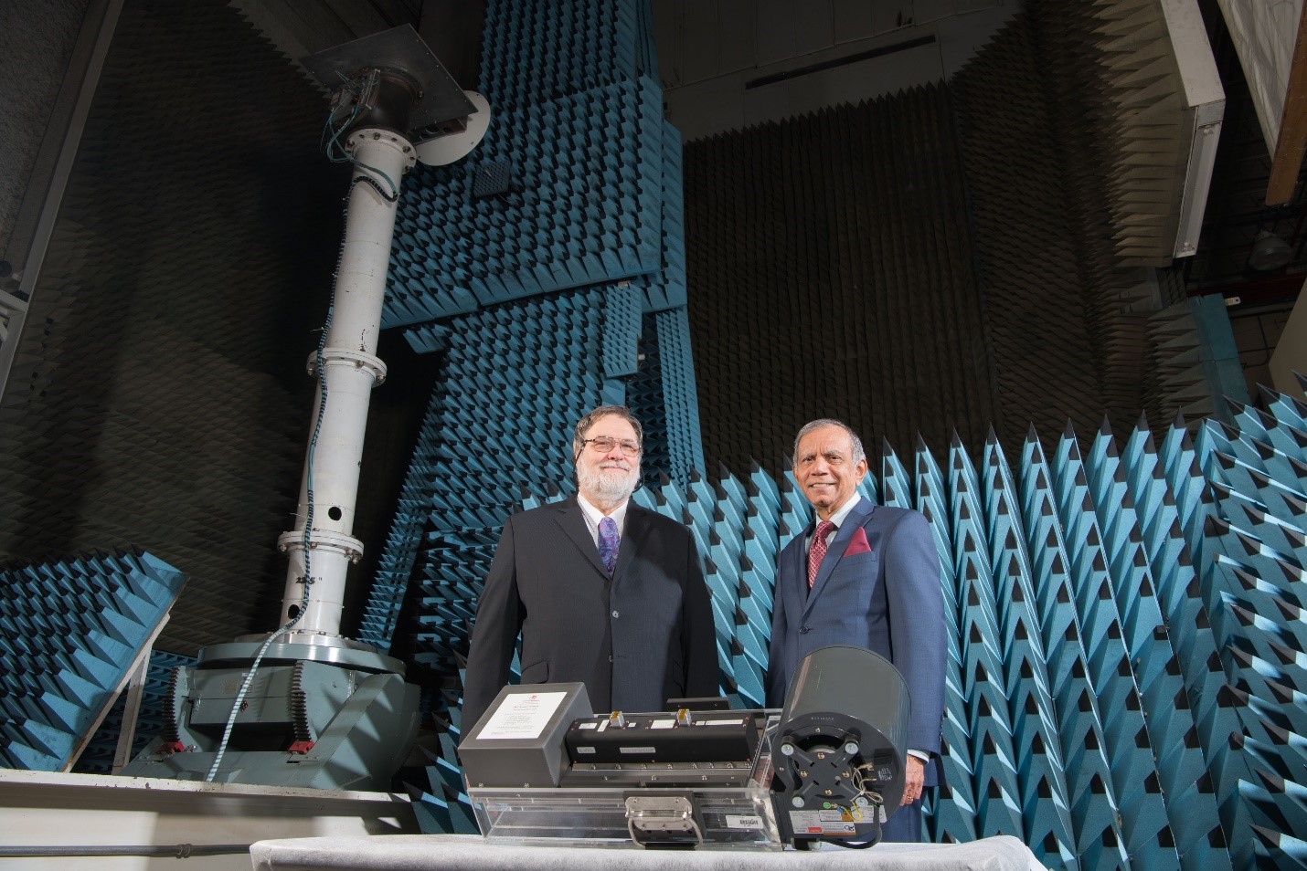 Space Technology Hall of Fame inductees, Dale Force and Dr. Rainee Simons, stand next to a 200-W Ka-band TWTA mounted on a cooling platform for lab testing. 