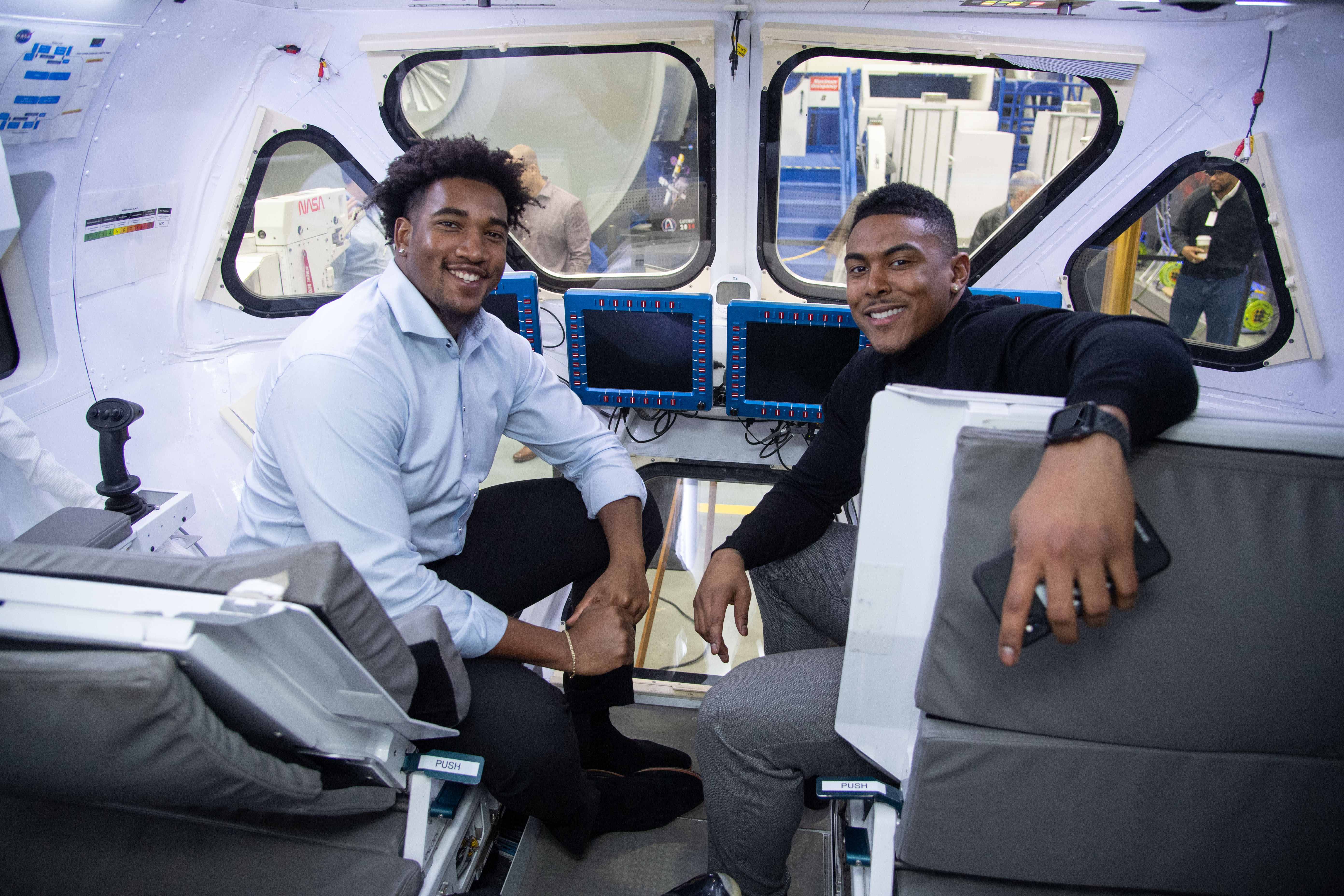 Eric Smith and Chris Peace try out the astronaut life from the driver seat at Johnson Space Center.