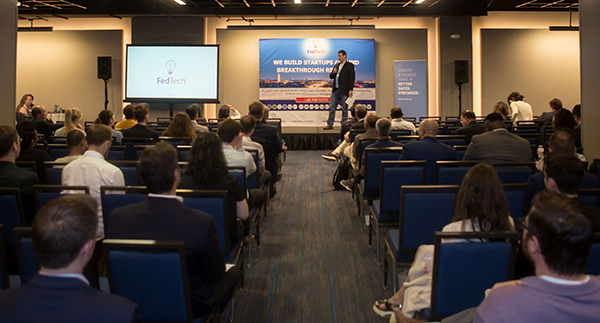 Ben Solomon speaks to a group of entrepreneurs at a FedTech showcase event, following the 16-week session in 2021. Participants pitch their final business concepts and receive feedback from judges. 