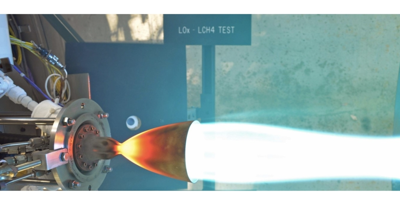 Rocket engine firing flames and smoke during test