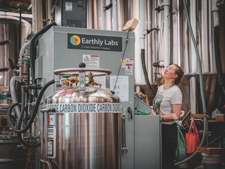 A brewer makes adjustments to the Earthly Labs carbon-capture unit, which purifies carbon dioxide from the beer brewing process for use in carbonation. Credit: Chart Industries Inc.