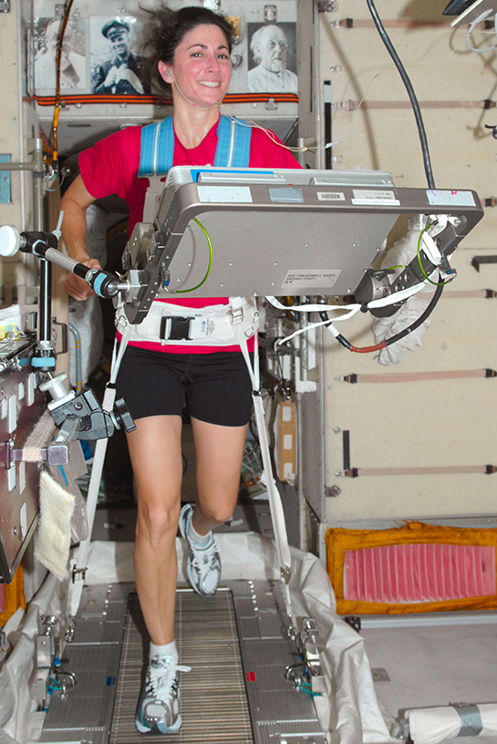  NASA astronaut Nicole Stott works out on a treadmill on the International Space Station