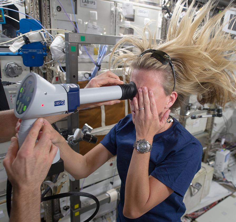  Astronaut Karen Nyberg undergoes an ocular health fundoscopic exam on the International Space Station