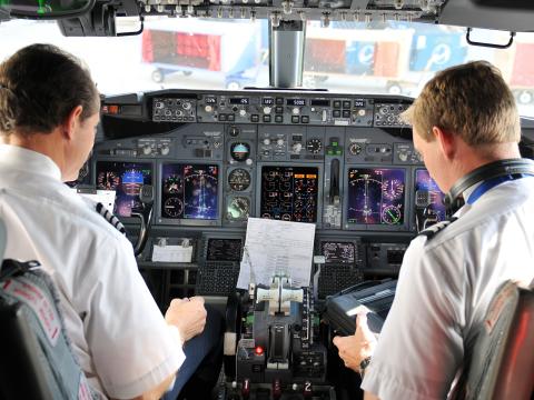 Two pilots use the foot pedal controller system in the aircraft