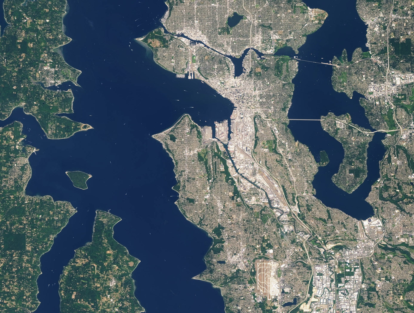 Landsat 7 image of Seattle, Washington acquired August 23, 2014. Landsat 7 is a U.S. satellite used to acquire remotely sensed images of the Earth's land surface and surrounding coastal regions. It is maintained by the Landsat 7 Project Science Office at the NASA Goddard Space Flight Center in Greenbelt, MD. Landsat satellites have been acquiring images of the Earths land surface since 1972. Currently there are more than 2 million Landsat images in the National Satellite Land Remote Sensing Data Archive.