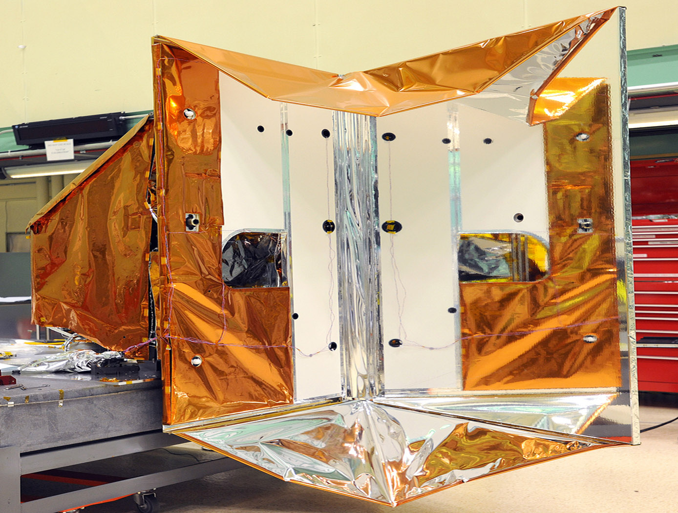 On the right side of the instrument is a large mirror. It's called the 'Earth Shield.' When it's in space it blocks the heat from Earth that would otherwise heat up the instrument. On the left is the instrument's radiator. The black dot in the center of the frame is the cold calibration point. The Thermal Infrared Sensor (TIRS) will fly on the next Landsat satellite, the Landsat Data Continuity Mission (LDCM). TIRS was built on an accelerated schedule at NASA's Goddard Space Flight Center, Greenbelt, Md. and will now be integrated into the LDCM spacecraft at Orbital Science Corp. in Gilbert, Ariz. The Landsat Program is a series of Earth observing satellite missions jointly managed by NASA and the U.S. Geological Survey. Landsat satellites have been consistently gathering data about our planet since 1972. They continue to improve and expand this unparalleled record of Earth's changing landscapes for the benefit of all.