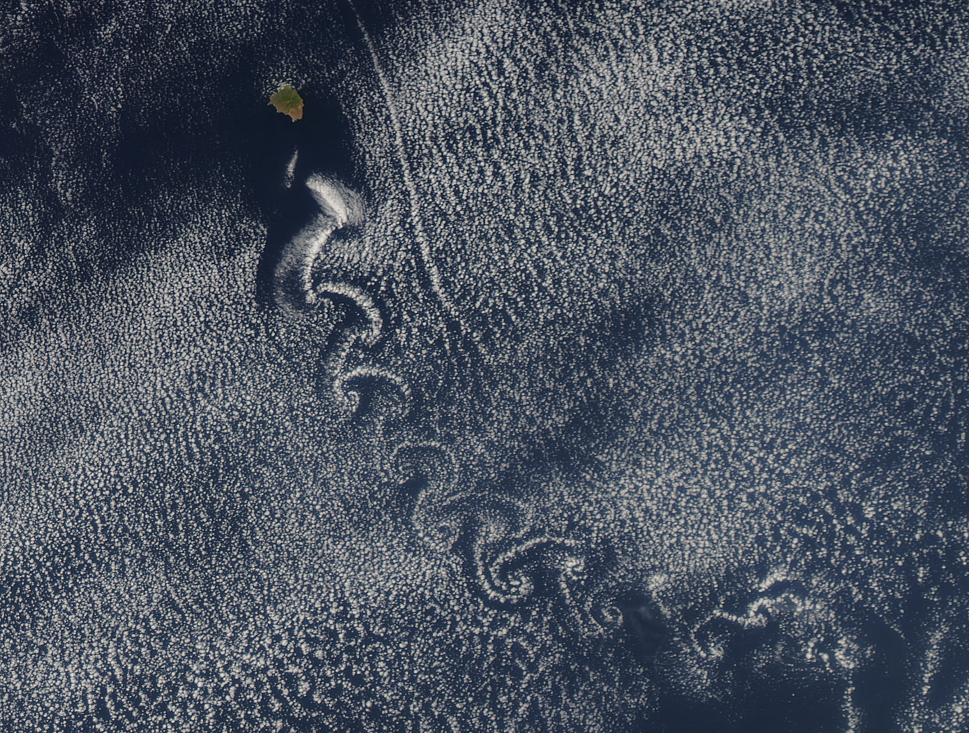 Swirl of Clouds over the Pacific; Credit: NASA Earth Observatory