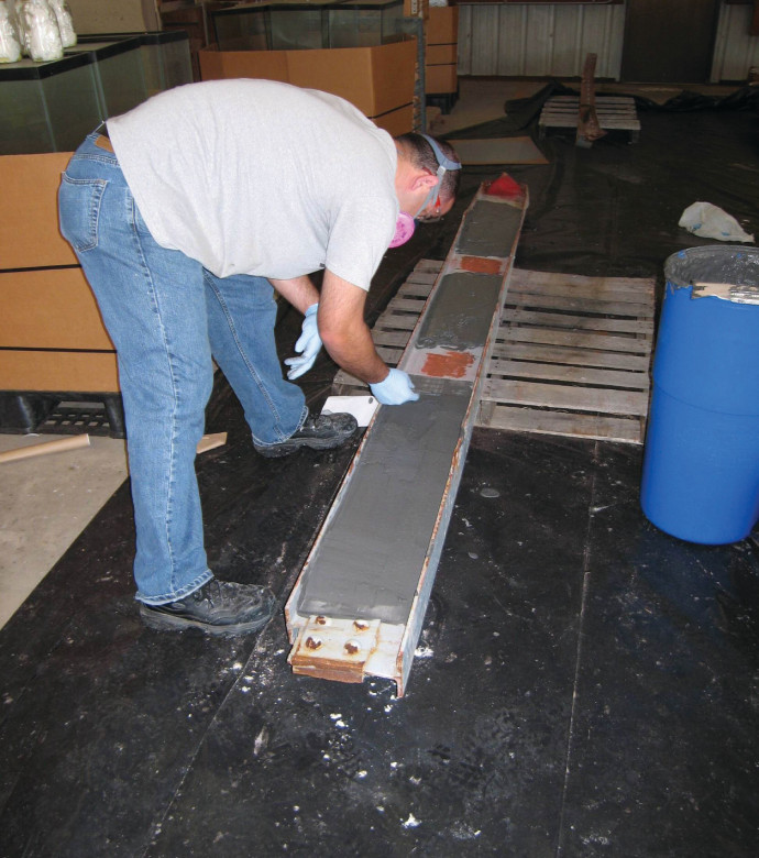AMTS paste being applied to an I-beam contaminated with PCB paint
