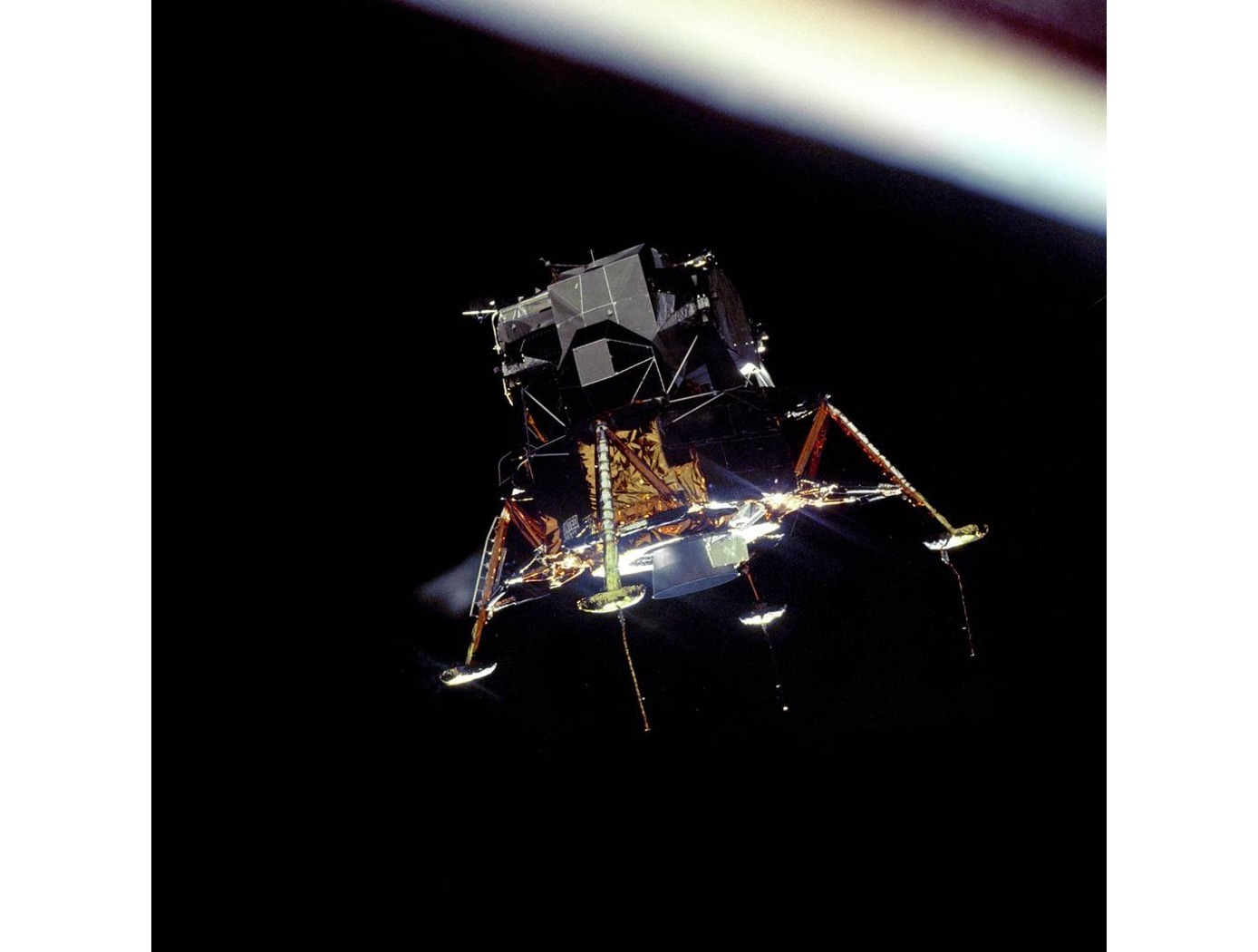 The Apollo 11 Lunar Module Eagle, in a landing configuration was photographed in lunar orbit from the Command and Service Module Columbia.