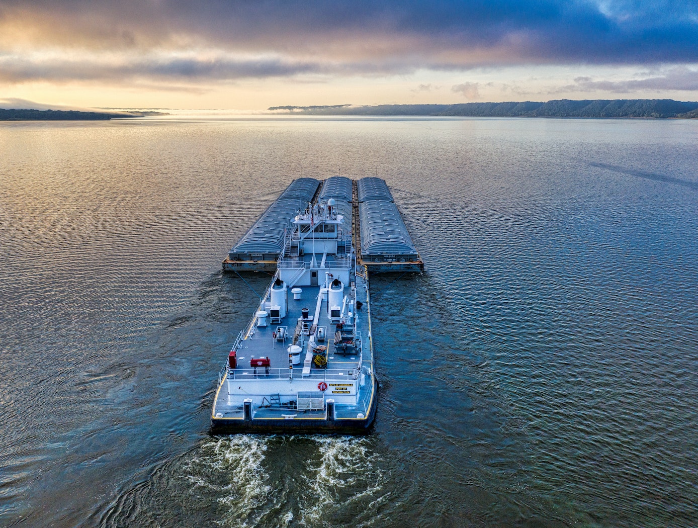 Royalty free stock photograph downloaded from https://www.pexels.com/photo/aerial-photography-of-a-barge-on-the-ocean-during-sunset-9552905/